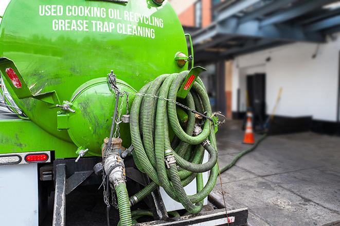 suction truck pumping grease trap for disposal in Big Rock